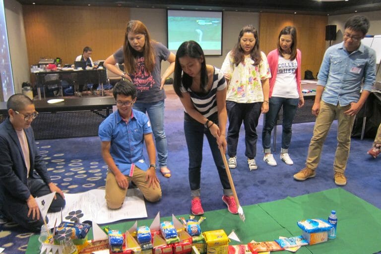 Delegates playing golf together on their sustainable pitch and putt course they built during their team building activity.