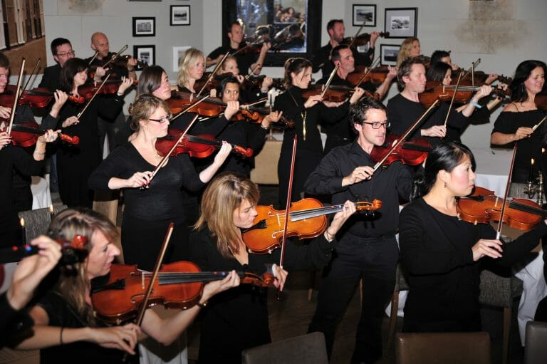 Delegates joined together, holding their violins for the finale performance to show what they've learned during Orchestrate.