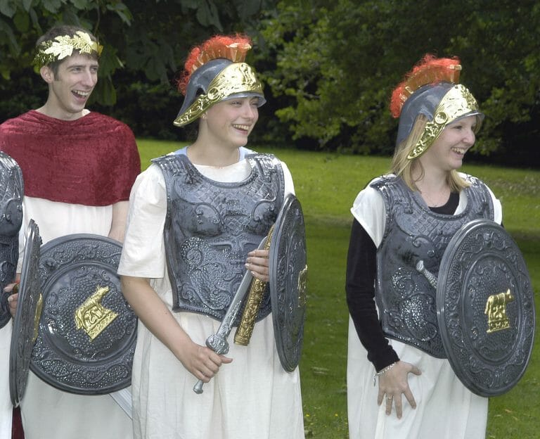 3 delegates dressed as roman soldiers while acting during one of Orangeworks fun, creative team building activities.