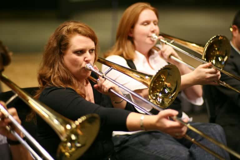 2 women playing the trumpets during Orchestrate, a musical team-building challenge by Orangeworks.