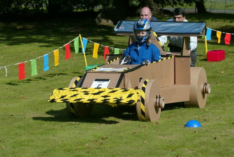 Delegates race their cardboard formula one cars that they built as part of their fun team-building activity for work.