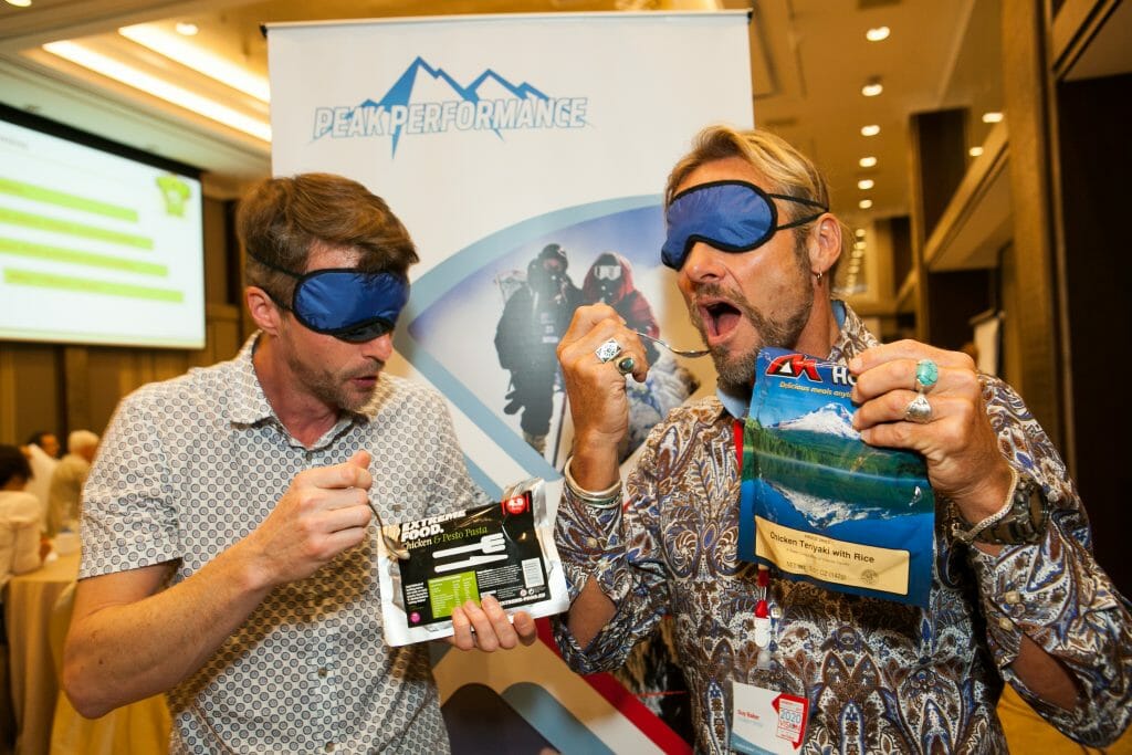 Delegates eating their expedition food during Peak Performance, a team engagement game by Orangeworks.