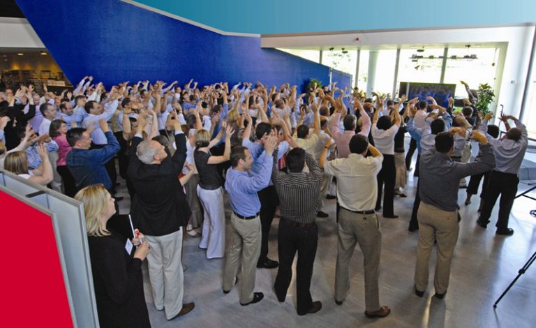 Delegates come together with arms in the air for the One Voice finale.