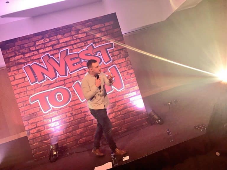 Dean, Orangeworks beatbox instructor standing on stage at a corporate conference event teaching delegates how to beatbox.