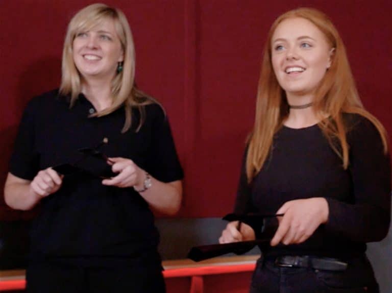 Delegates smile as they play their instruments during the Beatswork finale, a music related team building experience.