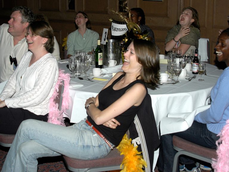 Delegates laughing while watching the Fifteen Famous Minutes movies they created during their staff away day with Orangeworks