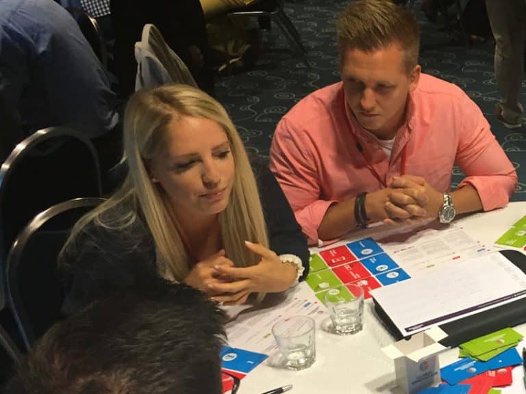 Delegates discuss their innovative ideas during Global Innovation Game, an innovative team building experience by Orangeworks