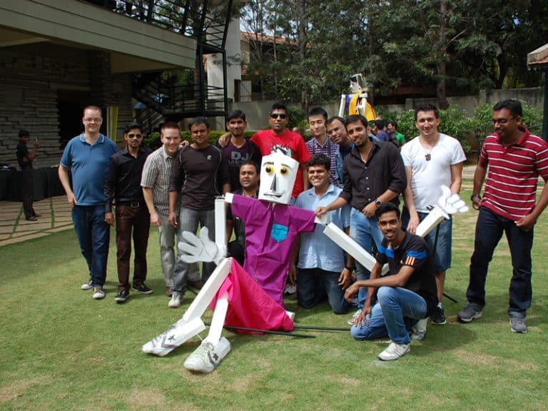 Delegates smiling with their completed puppet during Puppet Masters team building event by Orangeworks.