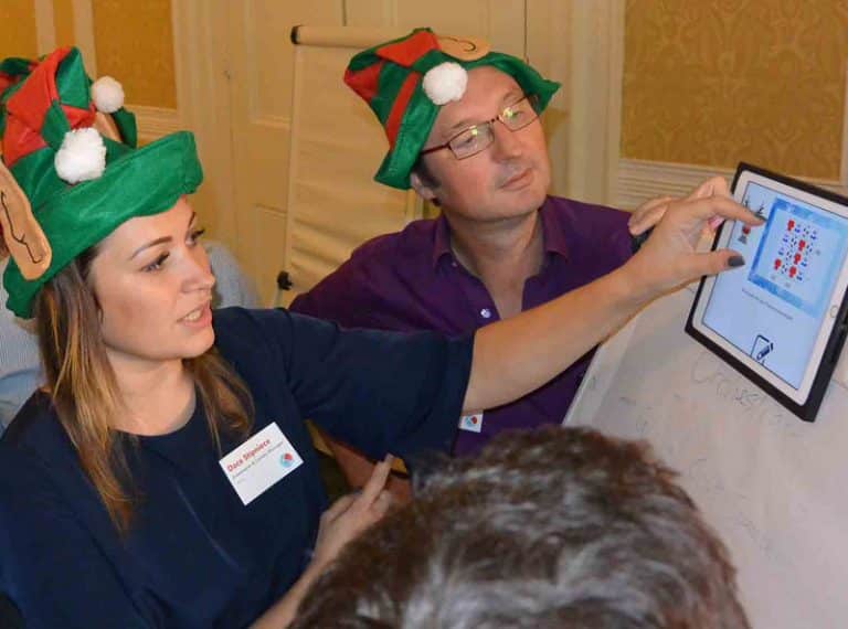 Delegates working on an iPad based challenge during Quickfire Christmas, a corporate Christmas party idea by Orangeworks.