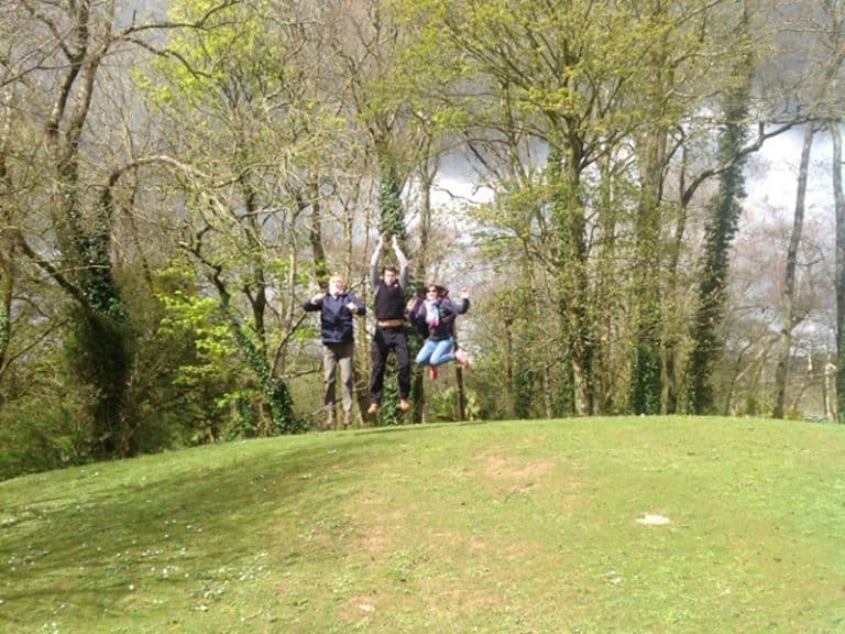 Happy team jumping in the air for a photo challenge during Go Team Fota Park treasure hunt