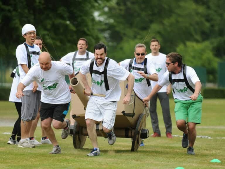 Delegates pulling their chariot during the finale race of the team building activity called Flat Out Chariots.