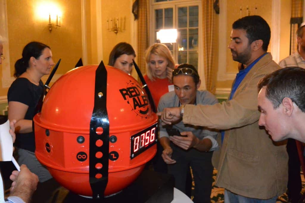 Delegates of Red Alert, an escape room style team building game run by Orangeworks, standing at the red sphere.