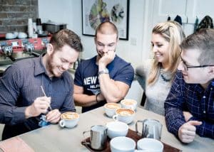 delegates learning latte art during a team building activity in dublin in the Dublin Barista School