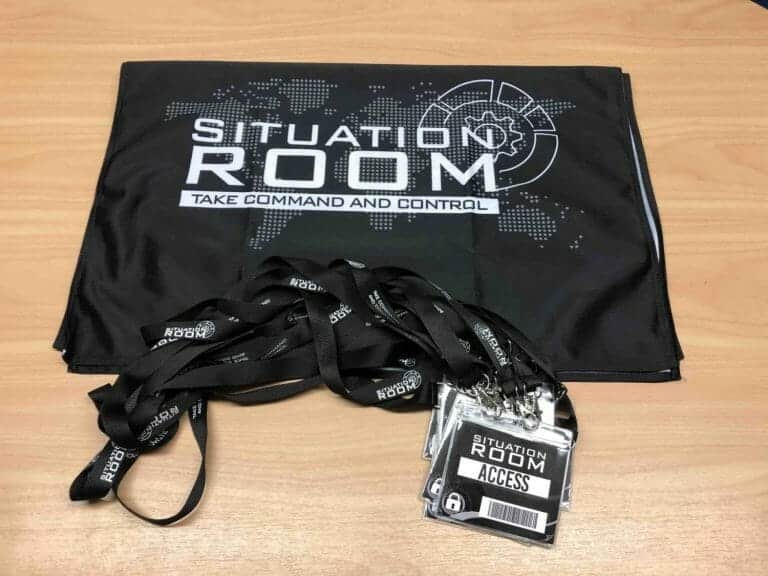 situation room bag laid out on a table with lanyards beside it.