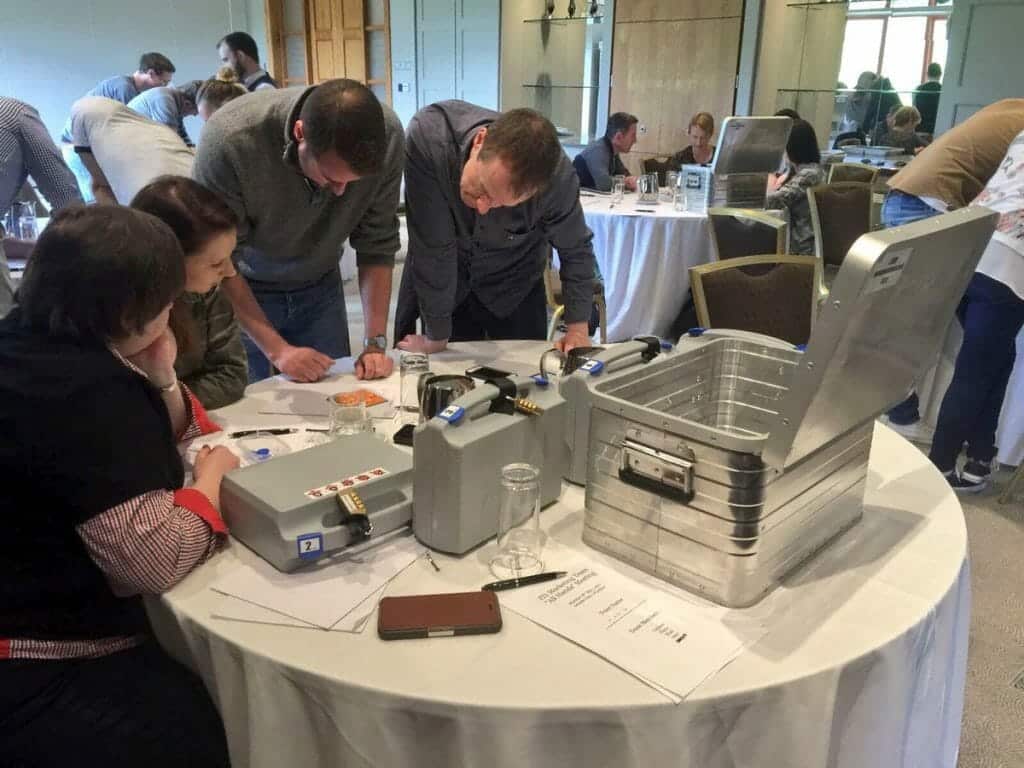 Delegates solving puzzles during their beat the box team building activity.