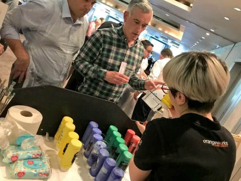 Alessia of Orangeworks giving delegates paint during the big picture team building event.