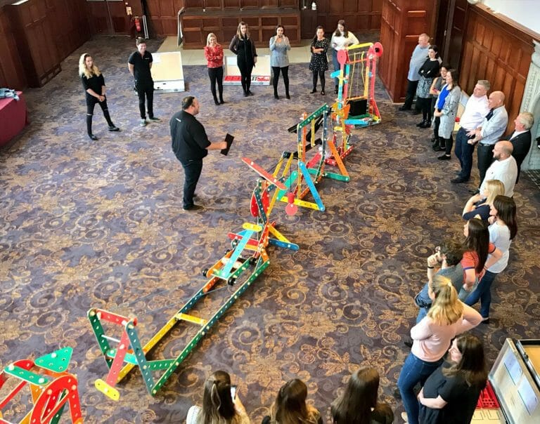 Orangeworks MC Oddie, showing a group of delegates how the team building game Plan of Action works.