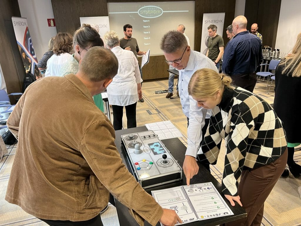 Delegates playing Synergyk - a collaborative AI bot driven team bonding challenge by Orangeworks.