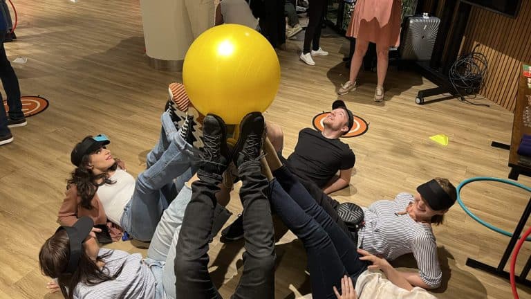 Delegates enjoying playing Drone Control together. Its a team building exercise where delegates fly drones through man-made obstacles.