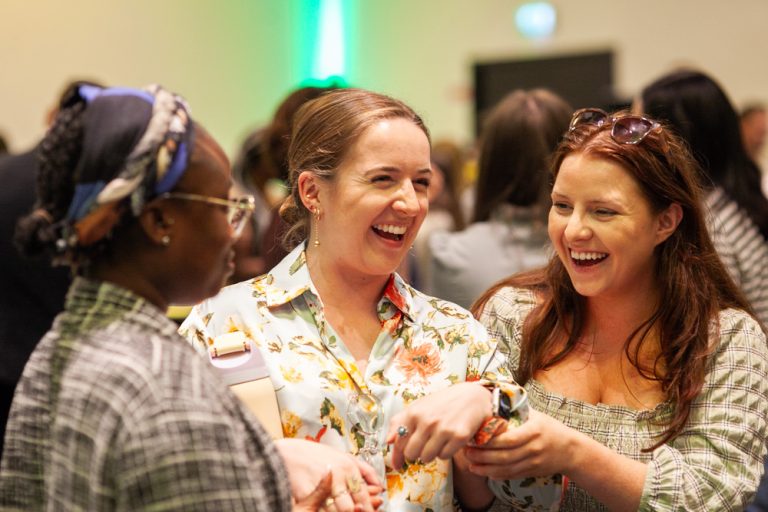 Delegates laughing and joking together during their team building activity called Beat the Box by Orangeworks.