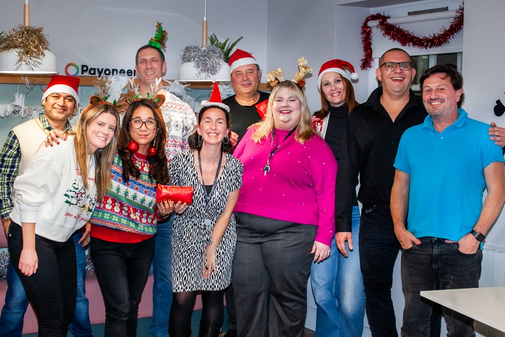 Group of delegates dressed in festive clothing standing together after their Christmas themed team bonding challenge with Orangeworks.