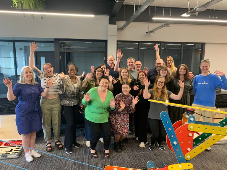 Delegates of Orangeworks team development workshop with the contraption they built as part of an experiential activity called Plan of Action.