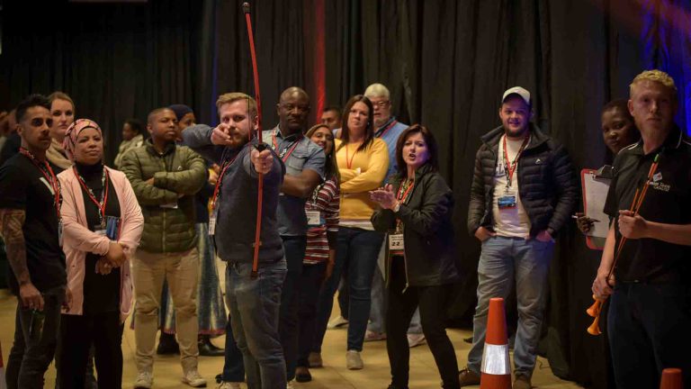 Participants playing indoor archery, as part of Orangeworks team building activity called Quickfire Olympics.
