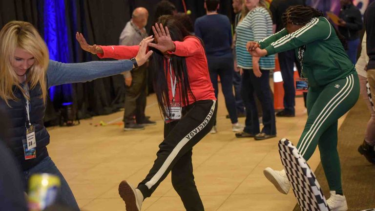 Delegates posing for a Quickfire challenge during Orangeworks team building activity Quickfire Olympics.