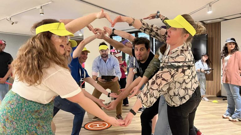 Delegates enjoying playing Drone Control together. Its a team building exercise where delegates fly drones through man-made obstacles.