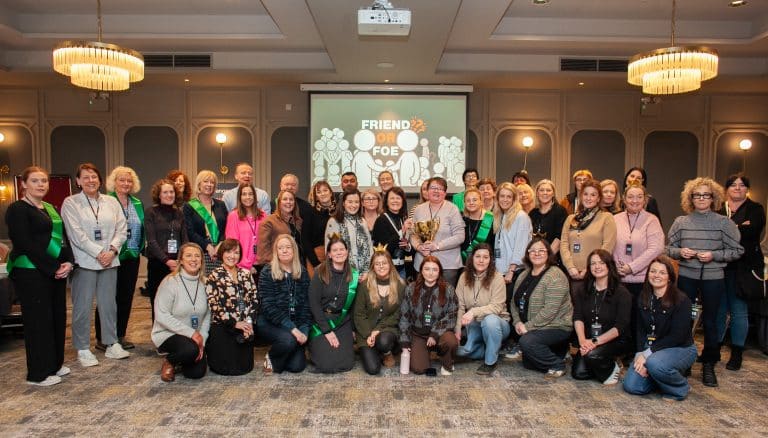 Delegates standing together after finishing their Orangeworks team activity called Friend or Foe - inspired by the hit tv show Traitors.