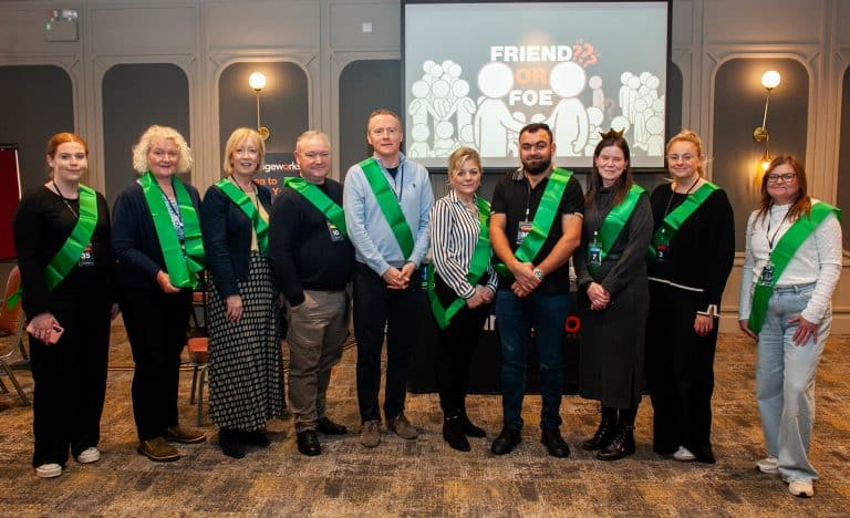 Delegates of Orangeworks Traitors inspired team bonding activity called Friend or Foe, wearing green sashes standing beside one another as they were all deemed the 'foes' of the game.
