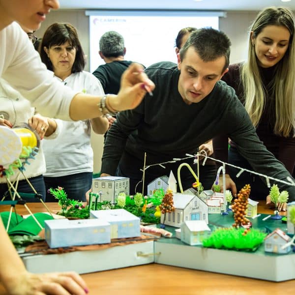 Delegates taking part in City Build, one of Orangeworks experiential activities that is played during a change management workshop.