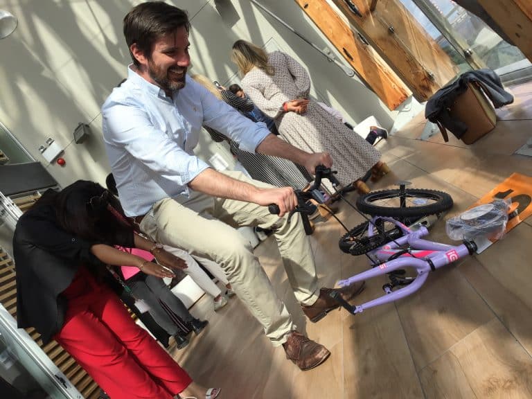 Delegates taking part in Orangeworks csr charity based activity where they build bikes and donate them to local charities.