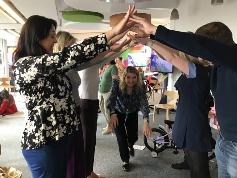 Delegates taking part in Orangeworks csr charity based activity where they build bikes and donate them to local charities.