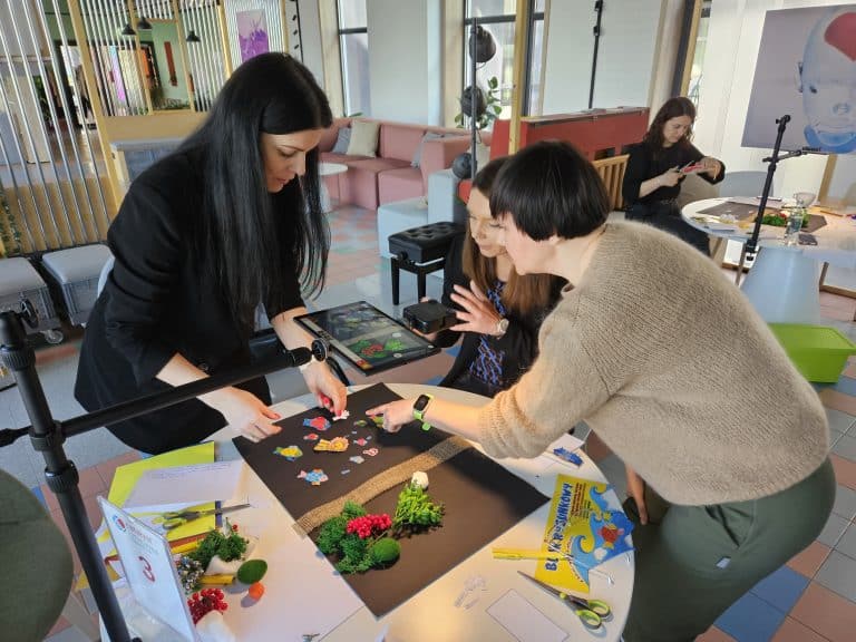 Delegates working together on their stop motion animation as part of their team building workshop provided by Orangeworks.