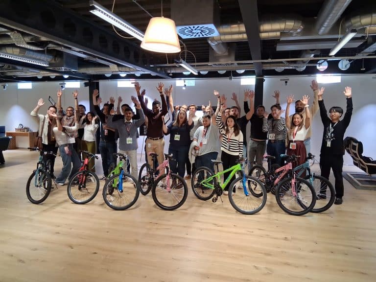 Delegates taking part in Orangeworks csr charity based activity where they build bikes and donate them to local charities.
