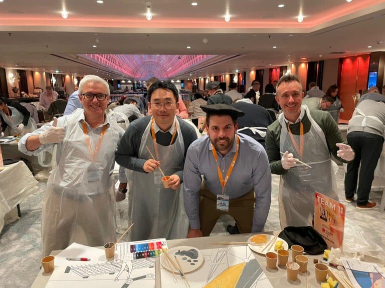 Delegates painting canvases as part of Orangeworks team activity called The Big Picture.