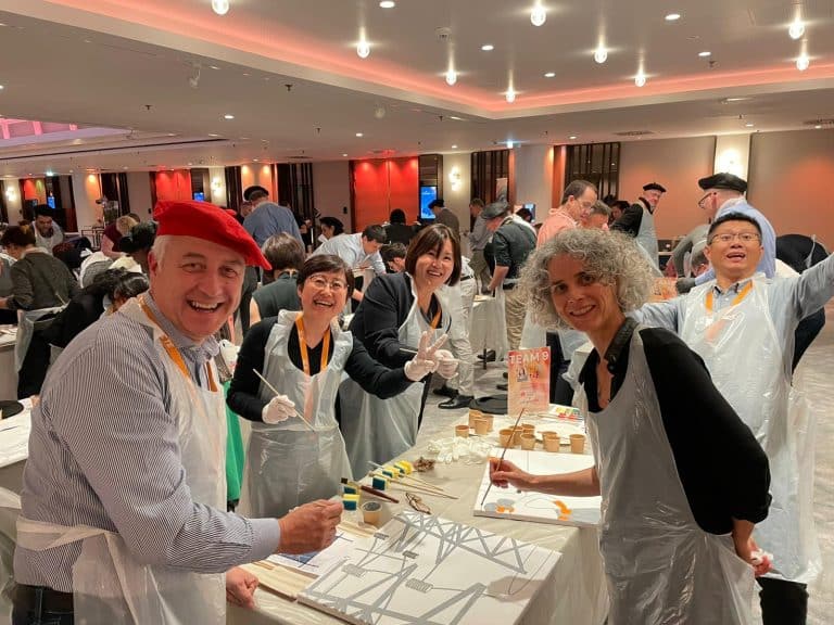 Delegates painting canvases as part of Orangeworks team activity called The Big Picture.