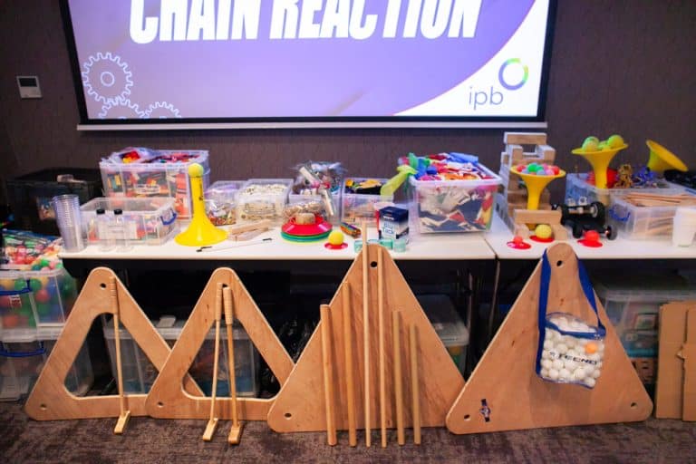 Delegates enjoying Orangeworks Chain Reaction challenge - working together to build a series of contraptions.