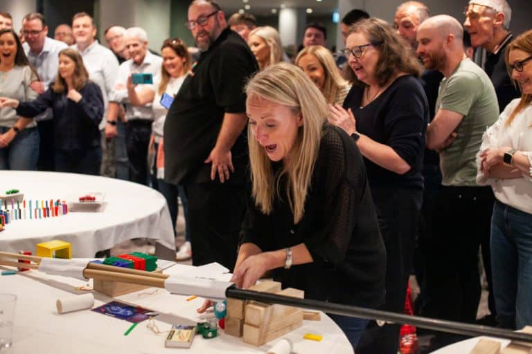 Delegates enjoying Orangeworks Chain Reaction challenge - working together to build a series of contraptions.