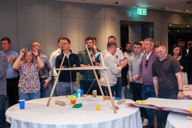 Delegates enjoying Orangeworks Chain Reaction challenge - working together to build a series of contraptions.