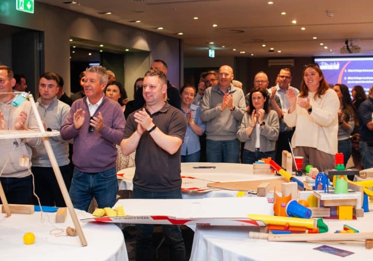 Delegates enjoying Orangeworks Chain Reaction challenge - working together to build a series of contraptions.