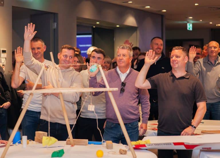 Delegates enjoying Orangeworks Chain Reaction challenge - working together to build a series of contraptions.