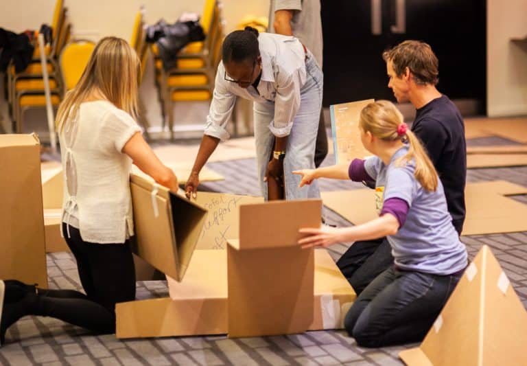 Delegates enjoying Orangeworks corporate team building challenge called Flat Out Formula where they build full size f1 cars from cardboard.