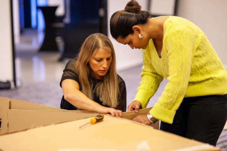Delegates enjoying Orangeworks corporate team building challenge called Flat Out Formula where they build full size f1 cars from cardboard.
