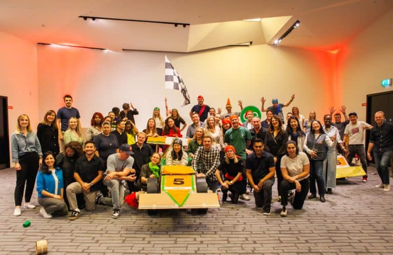 Delegates enjoying Orangeworks corporate team building challenge called Flat Out Formula where they build full size f1 cars from cardboard.