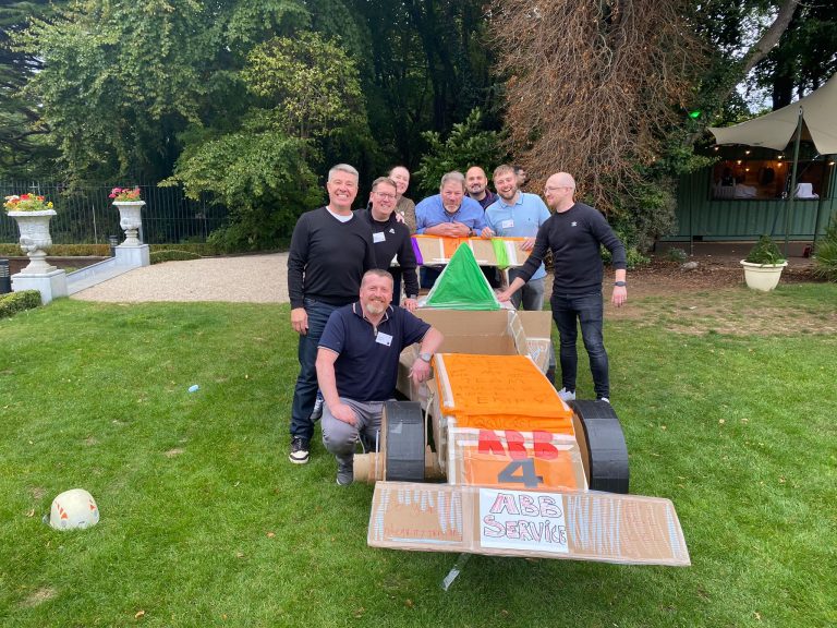 Delegates enjoying Orangeworks corporate team building challenge called Flat Out Formula where they build full size f1 cars from cardboard.