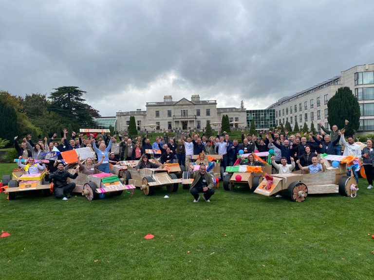 Delegates enjoying Orangeworks corporate team building challenge called Flat Out Formula where they build full size f1 cars from cardboard.