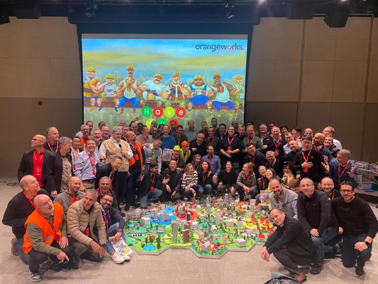 Delegates showcasing their miniature city that they built as part of Orangeworks creative construction based team activity called City Build.