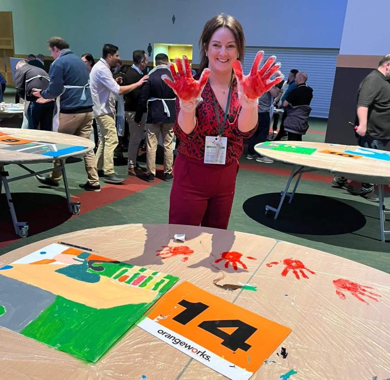 Delegates painting canvases as part of Orangeworks team activity called The Big Picture.